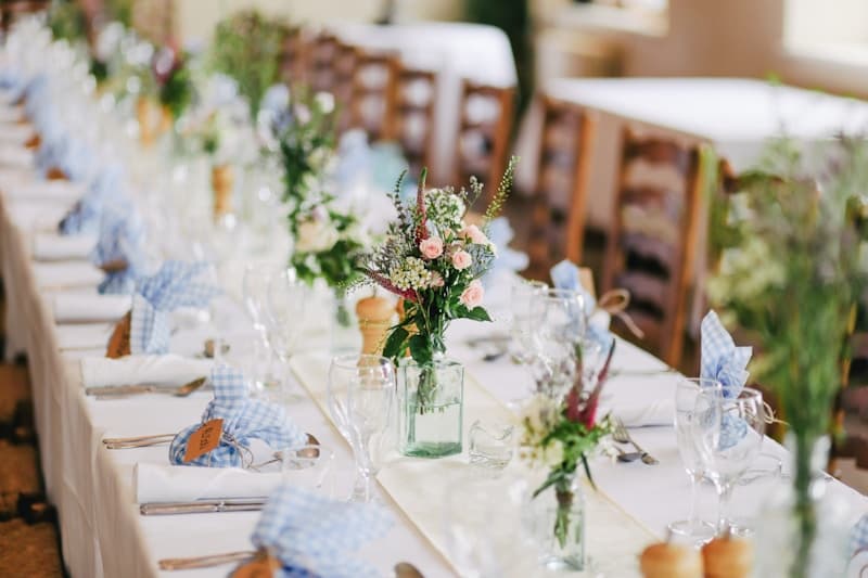 Flowers arranged along a wedding reception table